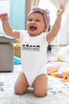 Tesla inspired apparel.  Elon Musk missing deadlines since day one. Deadlines image centered on baby onesie.