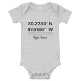 Tesla inspired apparel. Texas Gigafactory GPS coordinates. Birthplace Texas image centered on baby onesie.