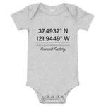 Tesla inspired apparel. Fremont Gigafactory GPS coordinates. Birthplace Fremont image centered on baby onesie.