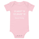 Tesla inspired apparel. Fremont Gigafactory GPS coordinates. Birthplace Fremont image centered on baby onesie.