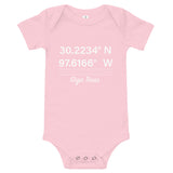 Tesla inspired apparel. Texas Gigafactory GPS coordinates. Birthplace Texas image centered on baby onesie.