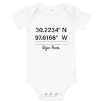 Tesla inspired apparel. Texas Gigafactory GPS coordinates. Birthplace Texas image centered on baby onesie.